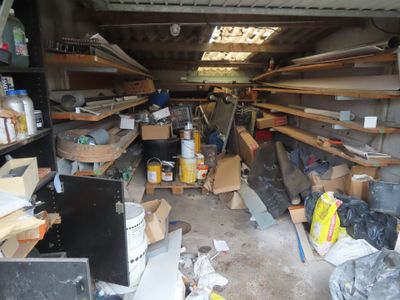 a garage filled with lots of clutter and boxes