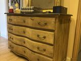 a dresser with a mirror on top of it in a room