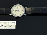 a watch that is sitting on a table with a name tag