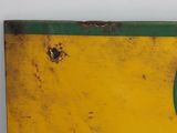 a yellow and green sign with a green shield on it