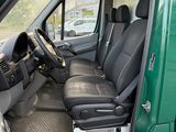 an image of a green van with black leather seats