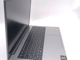 a silver laptop with a black keyboard on a white surface