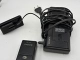 a small camera and a charger on a table