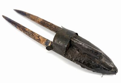 an old pair of tonges on a white surface