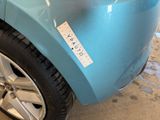 a blue car with a sticker on the side of it