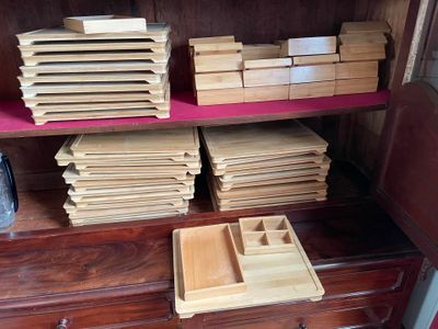 many wooden boxes on a shelf in a room