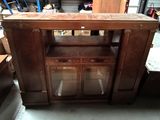 a wooden cabinet with glass doors in a room