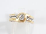 a gold and silver ring with a diamond on top