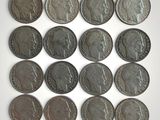 six different british coins are arranged in a row on a white surface
