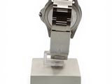 a watch that is on a stand on a white surface