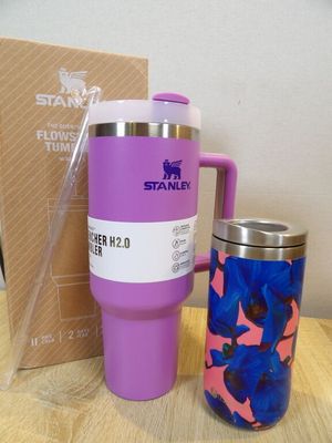 a purple mug and a blue and pink mug on a table