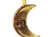 the gold crescent pendant has a chanel logo on it