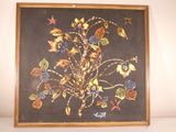 framed picture of a painting of flowers and leaves on a black background