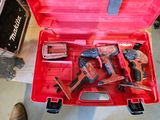 a red tool box with tools in it on the floor