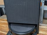 a black stove sitting on top of a wooden table