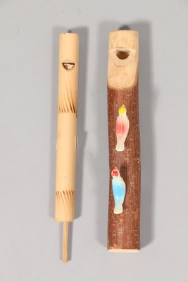 a wooden stick with a picture on it next to a wooden stick with a picture on it