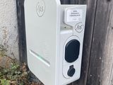 a white electronic device on the side of a wooden fence