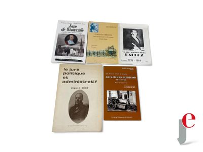 several books sitting on top of each other on a white surface