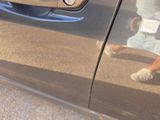 a reflection of a man walking on the side of a car
