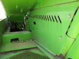 a close up of a green machine with a yellow sign on it