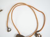 a necklace with a stone on a cord with a hook