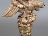 an image of a golden eagle on top of a glass bottle