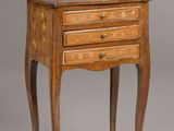 a small wooden table with three drawers and a drawer underneath it