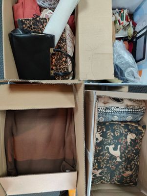 four boxes with different items in them sitting on the floor