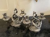 a group of silver candles on a black table