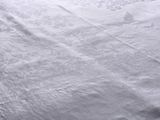 a bed with a white comforter and white sheets on it
