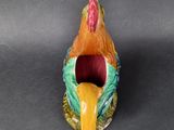 a colorful bird that is sitting on top of a table