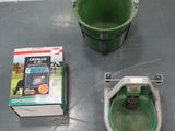 a green bucket sitting on the floor next to a green bucket