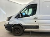 a white van that has been damaged and is in a garage