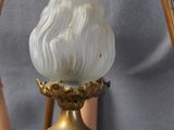 a black and gold vase with a white flower on top of it