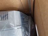 a box with a refrigerator inside of it that is wrapped in plastic