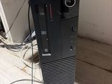 a black computer sitting on top of a wooden desk