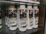many bottles of motor oil on a shelf in a store