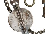 a metal chain with a wren and a key attached to it