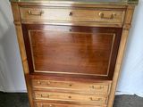 an image of a wooden cabinet with drawers and a mirror on top of it