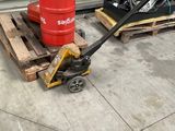 a red barrel sitting on a pallet next to a red barrel