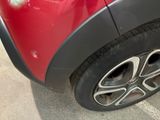 a close up of a red car with black rims
