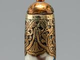 a white and blue vase with gold decoration on it