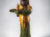 a statue of a man holding a bird on a plate