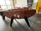 a foosball table in the middle of a living room