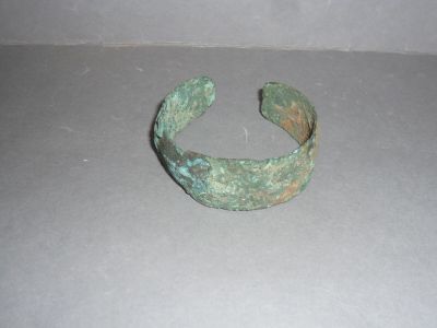 a close up of a metal bracelet on a table