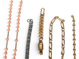many different types of necklaces on a white surface