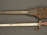 two old knives are sitting on a table next to each other