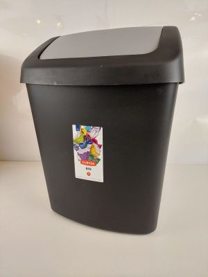 une poubelle noire sur laquelle est collé un autocollant