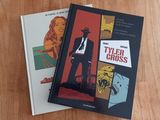 two books that are sitting on a wooden table