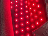 the back of a car seat with red leds and a remote control
